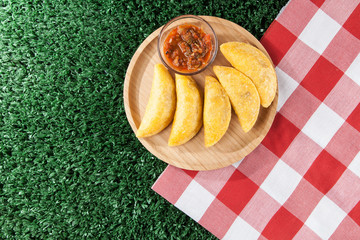Colombian empanada with spicy sauce.