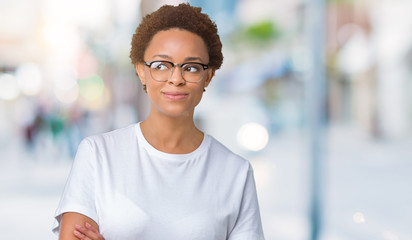 Beautiful young african american woman wearing glasses over isolated background smiling looking side and staring away thinking.