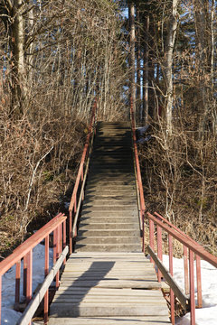 Boardwalker and stairs with railings ashore on a fall day in the park.