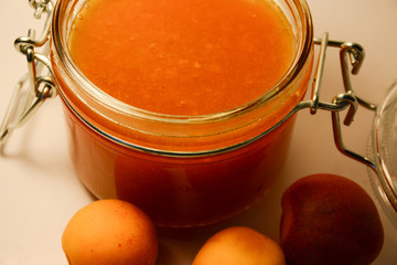  Closeup of apricot jam in a glass jar with a lid