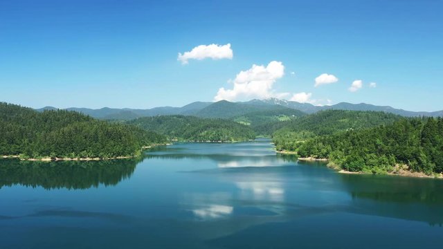 Panoramic view of beautiful Lokvarsko lake, drone flying over beautiful mountain landscape in Gorski kotar, Croatia, rising shot