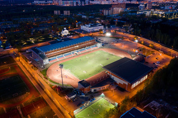 Fototapeta na wymiar Aerial view of footbal stadium in Dolgoprudny city at night