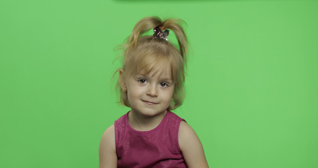 Positive girl looking to a camera in purple dress. Happy child. Chroma Key