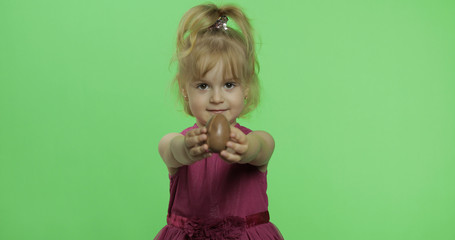 Girl in purple dress with chocolate egg. Happy four years old child. Chroma Key