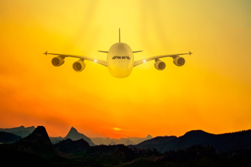 Commerical passenger plane in the clouds at amazing sunset