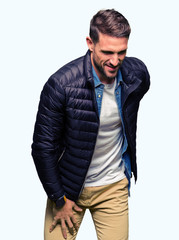 Fototapeta premium Handsome man wearing winter coat Suffering of backache, touching back with hand, muscular pain