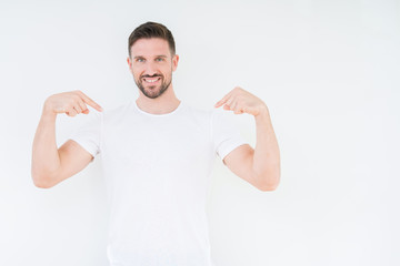 Young handsome man wearing casual white t-shirt over isolated background looking confident with...