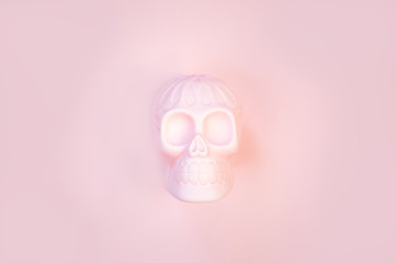 Halloween human pink skull on pastel background with free space for text.