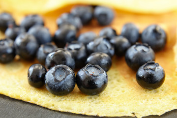 useful delicacy made from organic products, pancakes with blueberries, close-up of berries