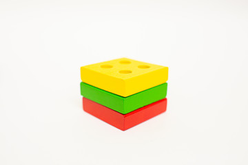 Toy wooden blocks, multicolor building construction bricks Lithuania flag. White background. Early education