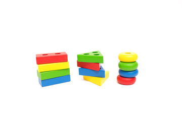 Toy wooden blocks, multicolor building construction bricks over white background. Early education concept