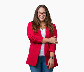 Beautiful plus size young business woman wearing elegant jacket and glasses over isolated background happy face smiling with crossed arms looking at the camera. Positive person.