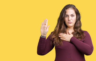Beautiful and attractive plus size young woman wearing a dress over isolated background Swearing...