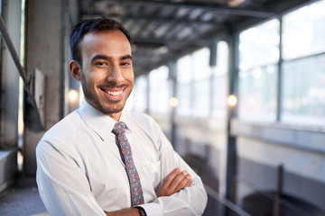 Indian businessman smiling confidently with cityscape background