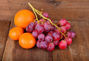 Orange and Grapes on wooden table