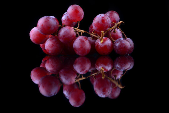 Bunch Of Red Grapes Isolated On Black Background