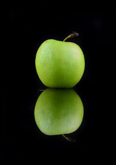 Green apple isolated on a black background