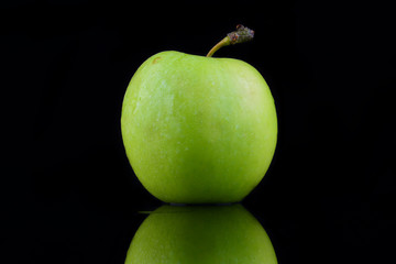 Green apple isolated on a black background