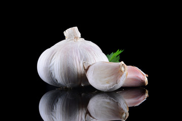 Garlic with reflection on black background