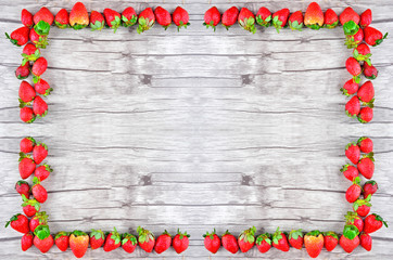 Strawberries over wooden background