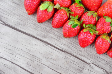 Strawberries over wooden background