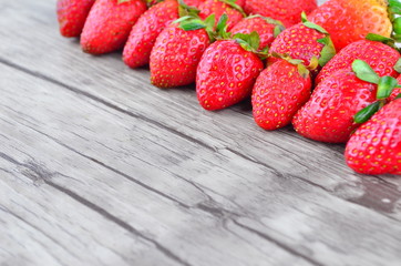 Strawberries over wooden background