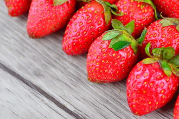 Strawberries over wooden background