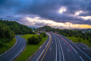 The day ends and we see the wake of the lights of the cars on the highway