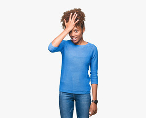 Beautiful young african american woman over isolated background surprised with hand on head for...