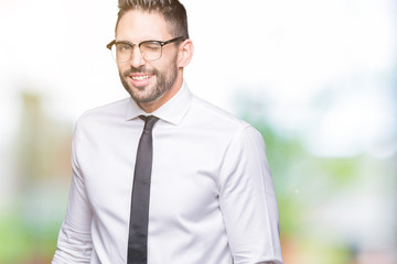 Young handsome business man wearing glasses over isolated background winking looking at the camera...
