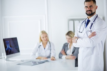 Happy doctor with medical staff at the hospital