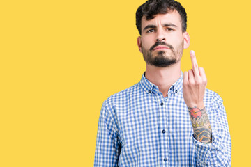Young handsome business man over isolated background Showing middle finger, impolite and rude fuck...
