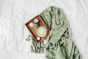 White bedding with dressing gown. Tray of coffee and candles. Breakfast in bed.  Scandinavian...