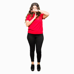 Young beautiful woman wearing casual t-shirt Doing time out gesture with hands, frustrated and...