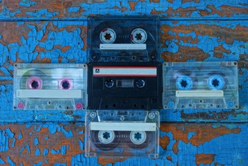 five old audio tapes are on the blue board