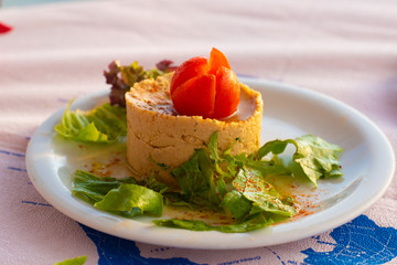 Authentic Mediterranean hummus served as an appetizer in a Greek restaurant on the island of Santorini.