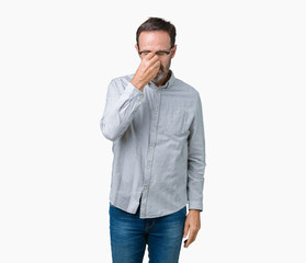 Handsome middle age elegant senior man wearing glasses over isolated background tired rubbing nose and eyes feeling fatigue and headache. Stress and frustration concept.