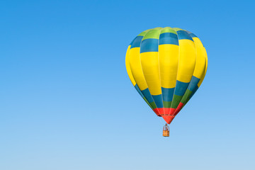 One colorful hot air balloon in blue sky