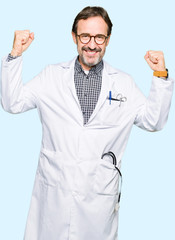Middle age doctor men wearing medical coat showing arms muscles smiling proud. Fitness concept.