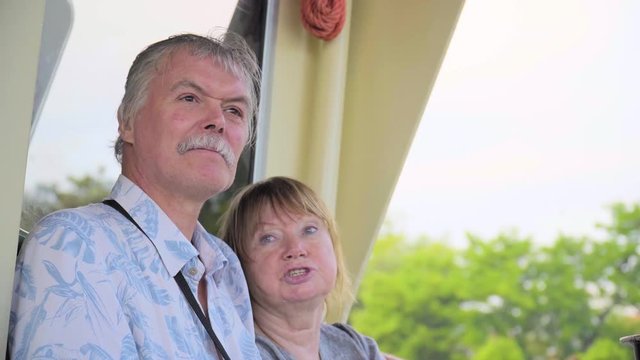 Senior Couple Relaxing On Boat Journey