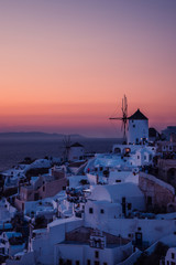 Fototapeta premium The white village of Oia, on the island of Santorini, Greece during a romantic red sunset.