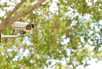 Closed circuit camera on the green bokeh background