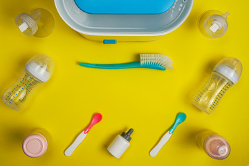 Fototapeta na wymiar Baby sterilizer brush with plastic feeding accessories