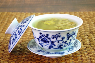 Chrysanthemum tea. Chinese tradition chrysanthemum tea in beautiful blue and white porcelain cup, famous herbal tea from Huangshan , Anhui China. Selective focus, space for texts