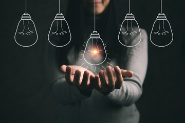 Businesswoman Houlding light bulb