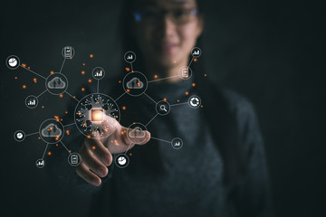 Big data analytics and business intelligence concept with chart and graph icons on a digital screen interface and a businesswoman in background