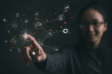 Big data analytics and business intelligence concept with chart and graph icons on a digital screen interface and a businesswoman in background