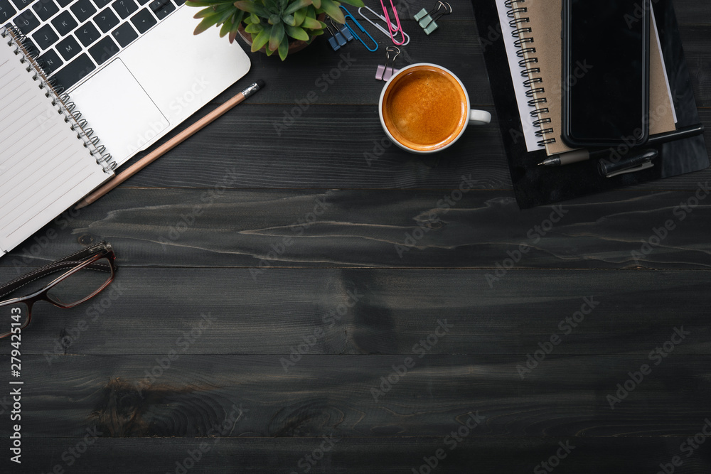 Poster modern dark wood office desk table with laptop, smartphone and other supplies with cup of coffee. bl