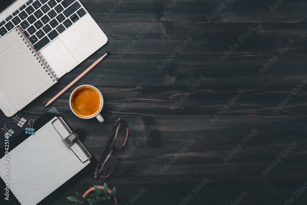Poster modern dark wood office desk table with laptop, smartphone and other supplies with cup of coffee. bl
