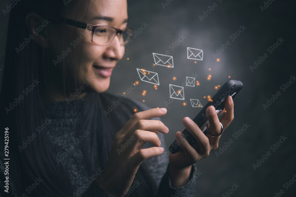 Poster woman sending e-mail message to mailing list contacts using smartphone,